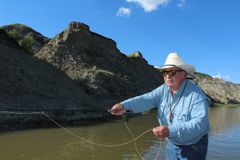 Casting a flyrod for grayling in the Red Deer River badlands
